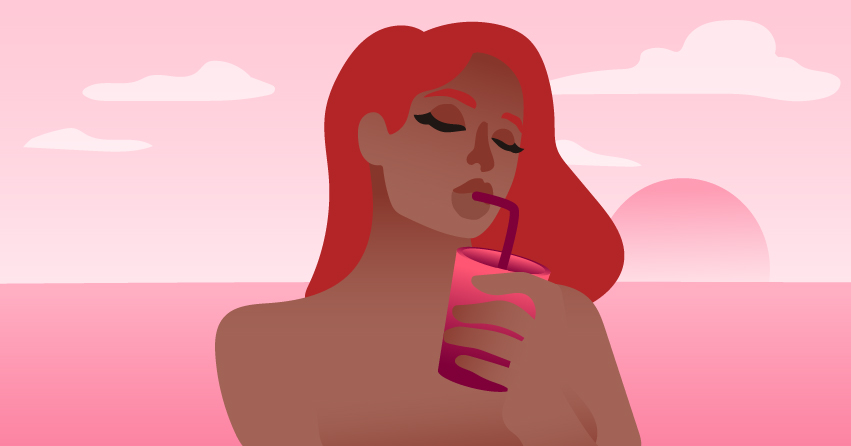 A woman sensually sipping a drink. 